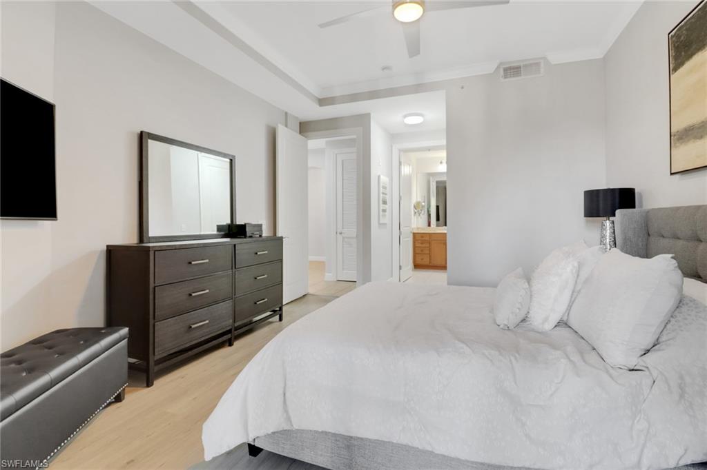 8011 Via Monte Carlo Way, Unit 2208 Estero, FL 33928 - Photo 18 of 34 a bedroom with a bed and flat screen tv