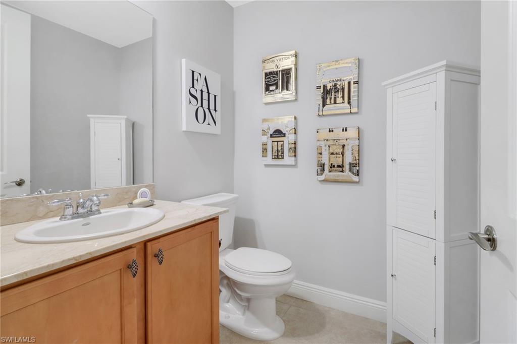 8011 Via Monte Carlo Way, Unit 2208 Estero, FL 33928 - Photo 21 of 34 a bathroom with a toilet a sink and mirror
