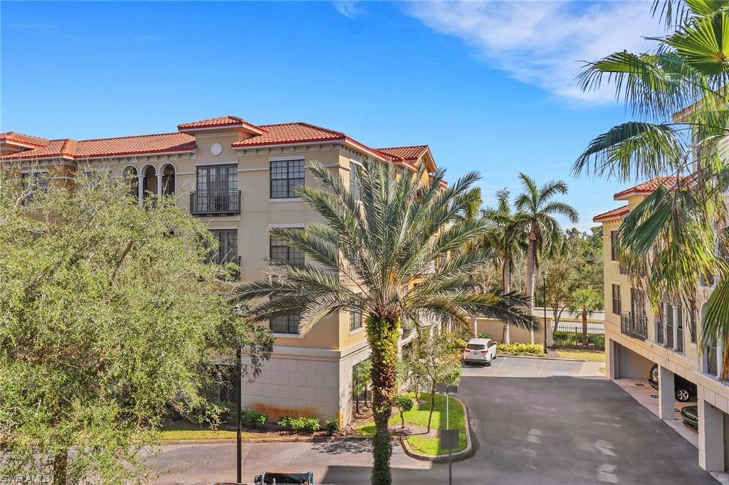 8011 Via Monte Carlo Way, Unit 2208 Estero, FL 33928 - Photo 23 of 34 a view of a palm trees in front of a building