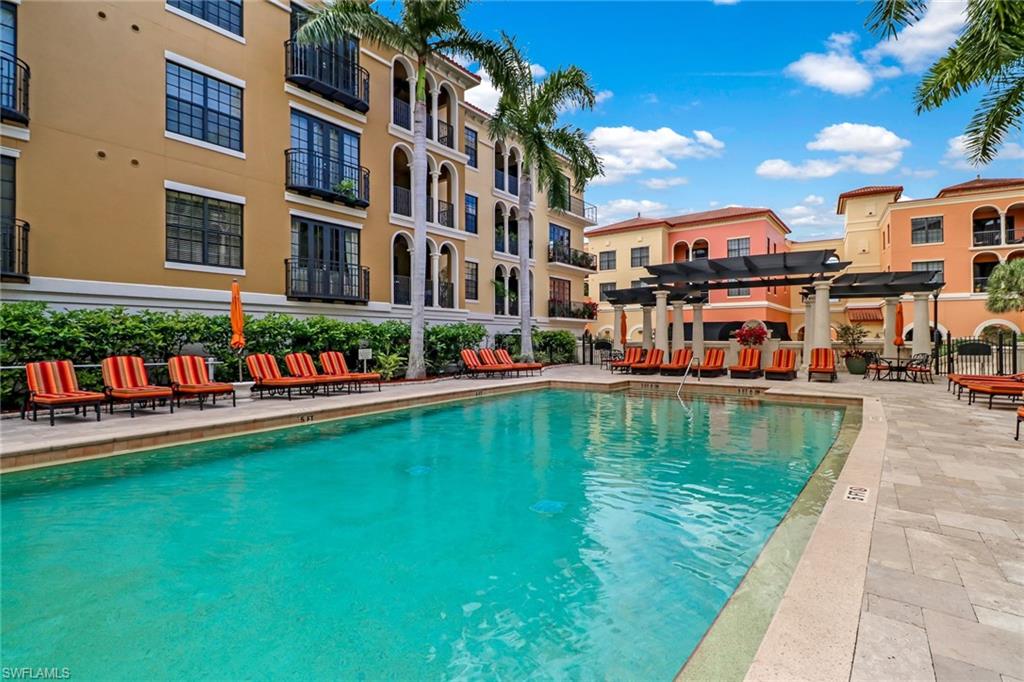 8011 Via Monte Carlo Way, Unit 2208 Estero, FL 33928 - Photo 27 of 34 a swimming pool view with a outdoor seating