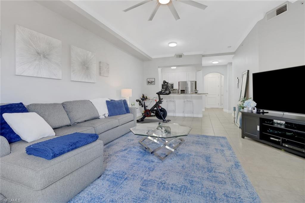 8011 Via Monte Carlo Way, Unit 2208 Estero, FL 33928 - Photo 10 of 34 a living room with furniture and a flat screen tv