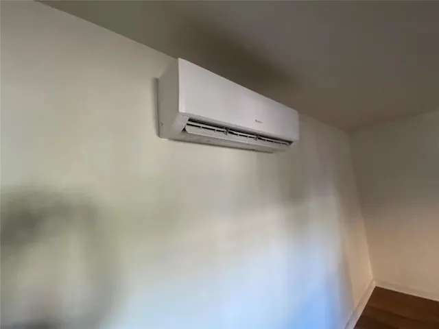 a room with wooden floor and windows