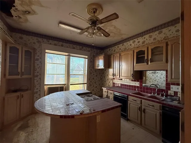 a view of an empty room with a fireplace and a window