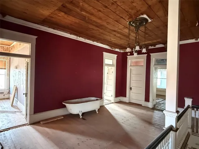 a view of a livingroom with wooden floor and a fireplace