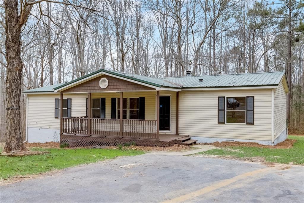 178 Covered Bridge Road Covington, GA 30016 - Photo 1 of 1 a front view of a house with a yard