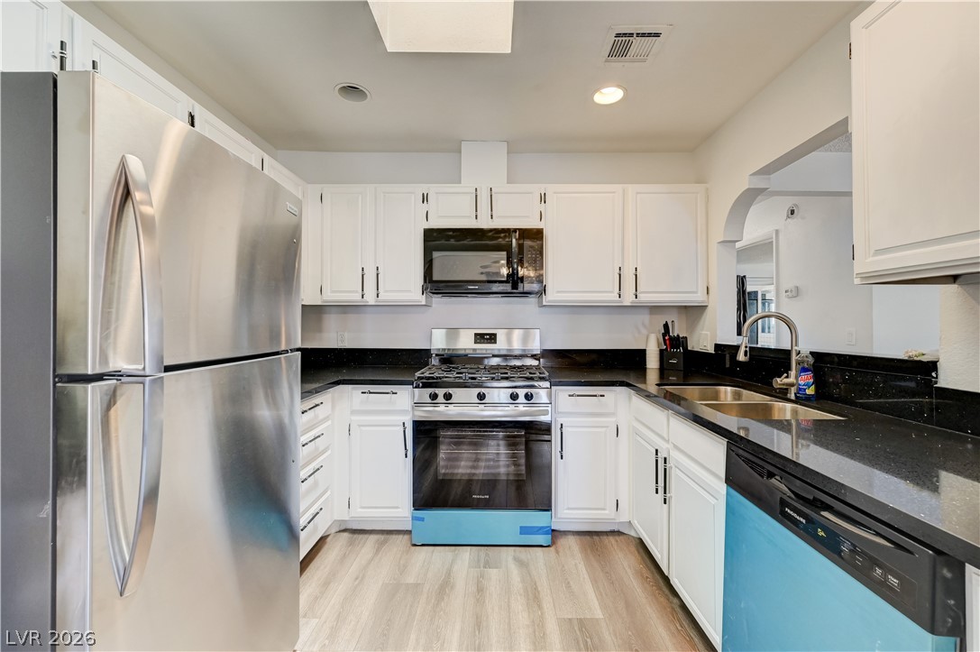 1751 East Reno Avenue, Unit 228 Las Vegas, NV 89119 - Photo 15 of 39 Culinary creations come to life in this kitchen, featuring ample counter space and modern appliances.