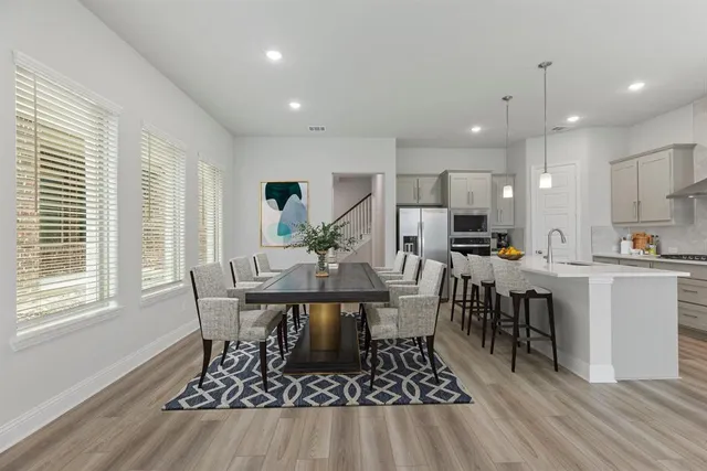 a view of a dining room with furniture and wooden floor