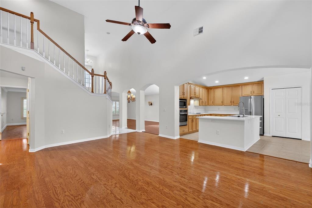 729 Strihal Loop Oakland, FL 34787 - Photo 17 of 49 a view of a kitchen with wooden floor and a ceiling fan