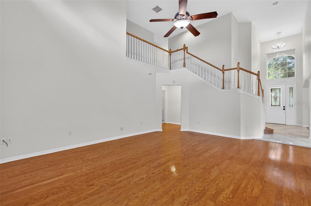 729 Strihal Loop Oakland, FL 34787 - Photo 18 of 49 a view of empty room with wooden floor