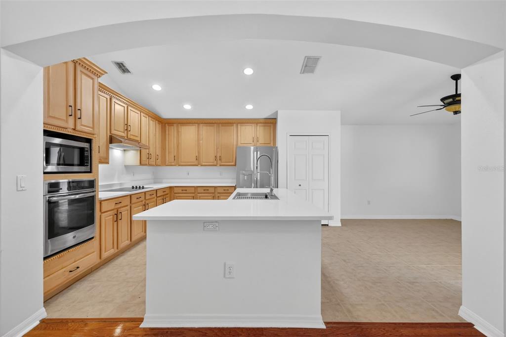 729 Strihal Loop Oakland, FL 34787 - Photo 19 of 49 a kitchen with stainless steel appliances granite countertop a refrigerator and a stove