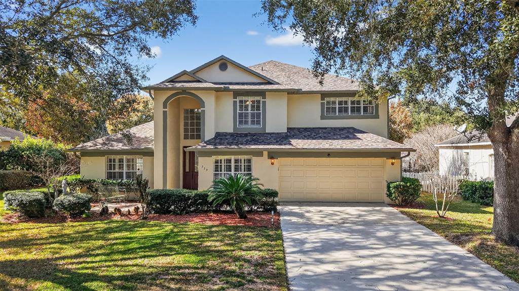 729 Strihal Loop Oakland, FL 34787 - Photo 2 of 49 a front view of a house with a yard