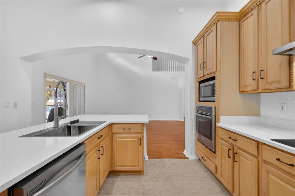 729 Strihal Loop Oakland, FL 34787 - Photo 22 of 49 a kitchen with cabinets and oven