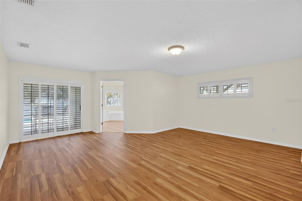 729 Strihal Loop Oakland, FL 34787 - Photo 25 of 49 a view of an empty room with wooden floor and a window