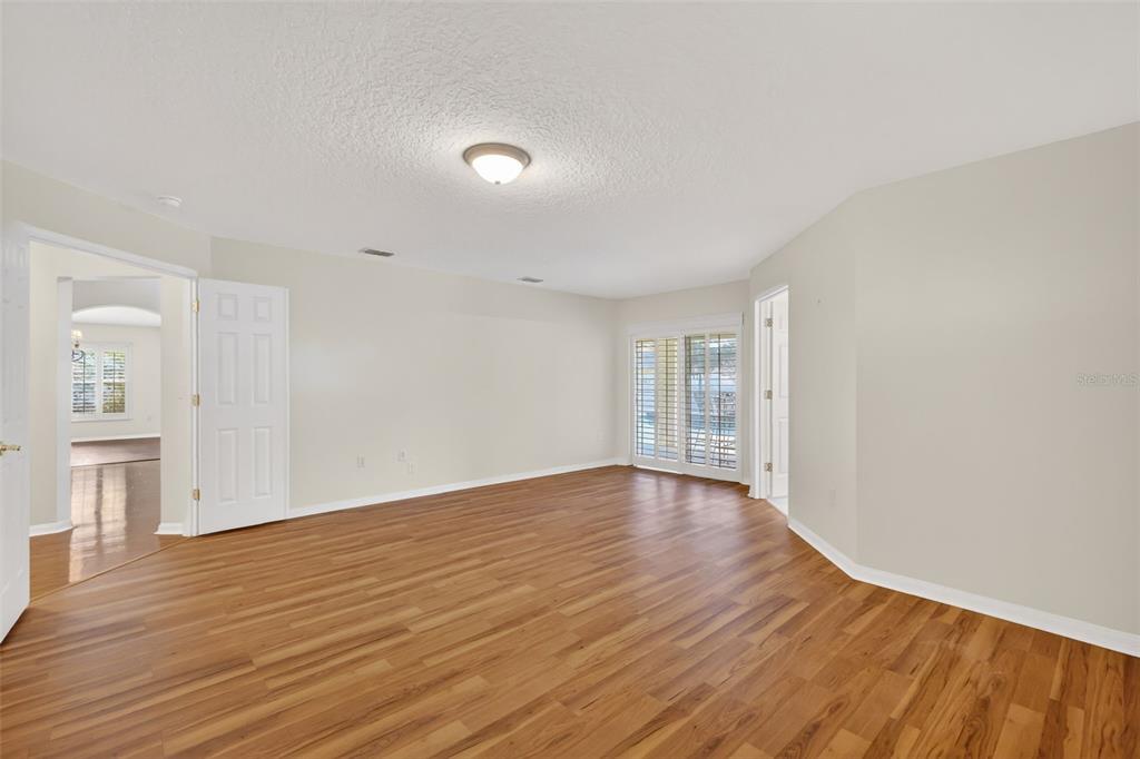 729 Strihal Loop Oakland, FL 34787 - Photo 27 of 49 a view of an empty room with wooden floor and a window