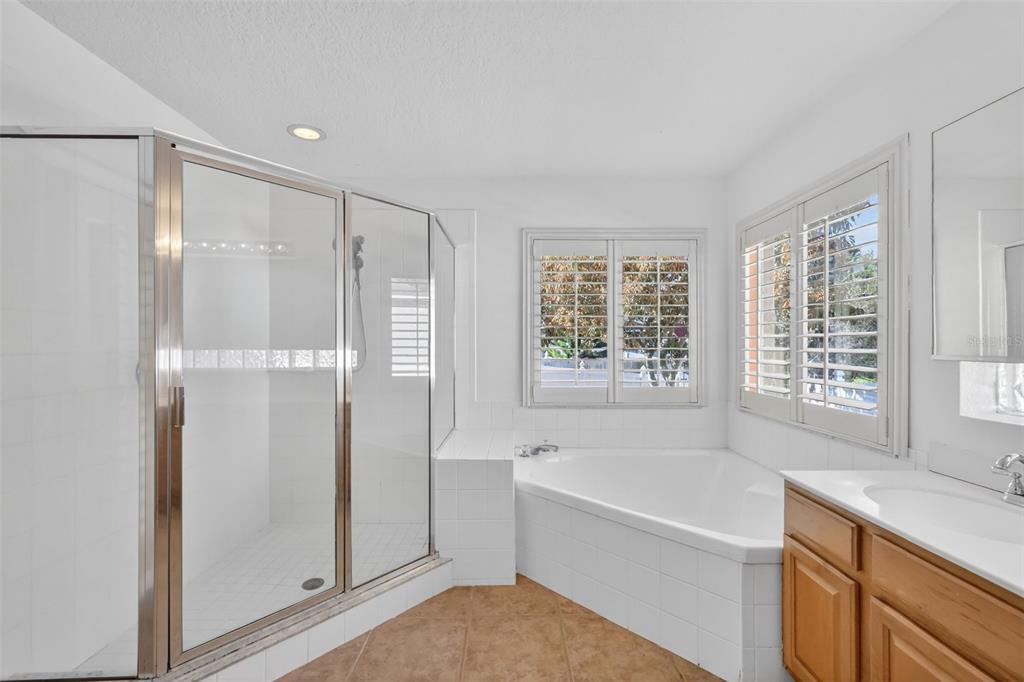 729 Strihal Loop Oakland, FL 34787 - Photo 30 of 49 a bathroom with a bathtub and a shower