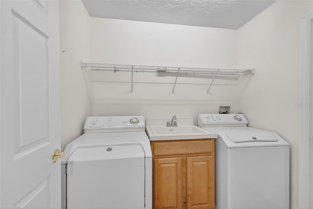 729 Strihal Loop Oakland, FL 34787 - Photo 31 of 49 a utility room with dryer and washer