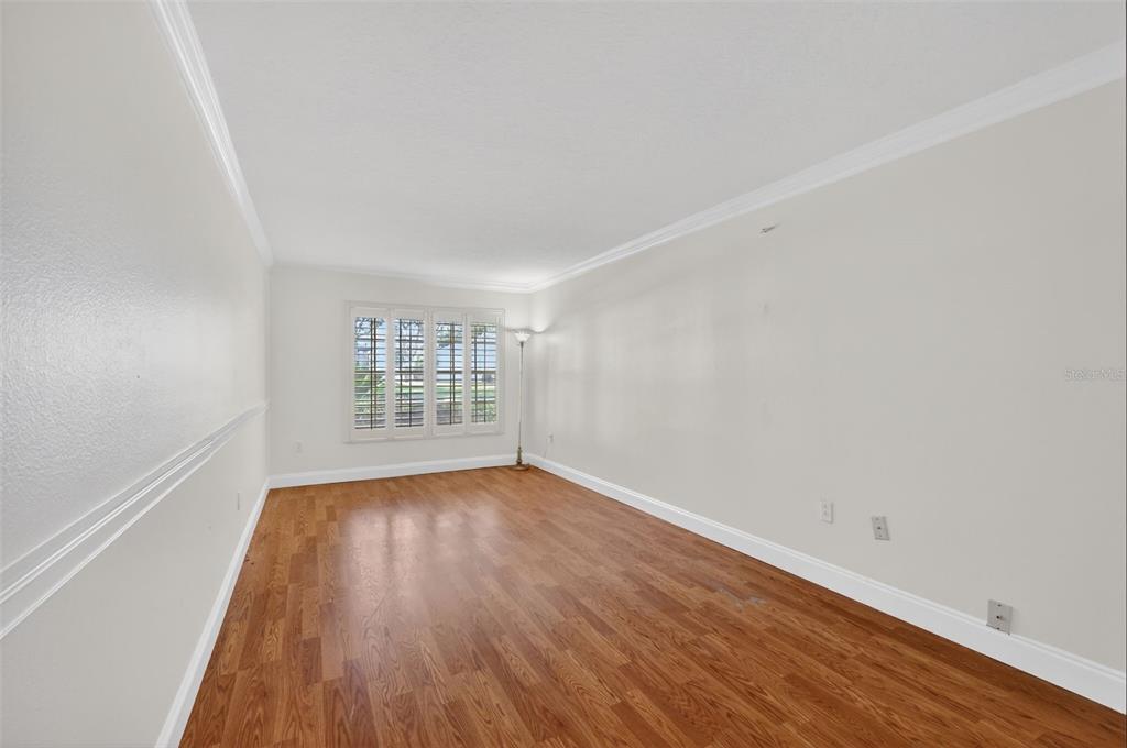 729 Strihal Loop Oakland, FL 34787 - Photo 33 of 49 an empty room with wooden floor and windows