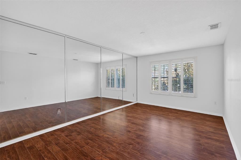 729 Strihal Loop Oakland, FL 34787 - Photo 34 of 49 a view of an empty room with wooden floor and a window