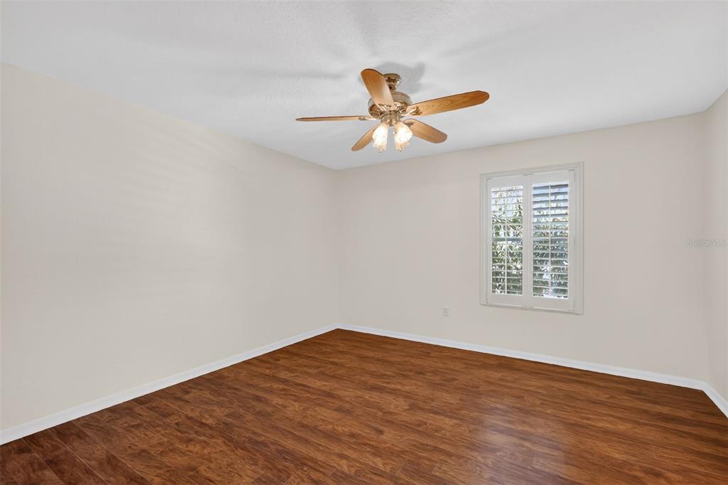 729 Strihal Loop Oakland, FL 34787 - Photo 35 of 49 a view of an empty room with a window and a ceiling fan