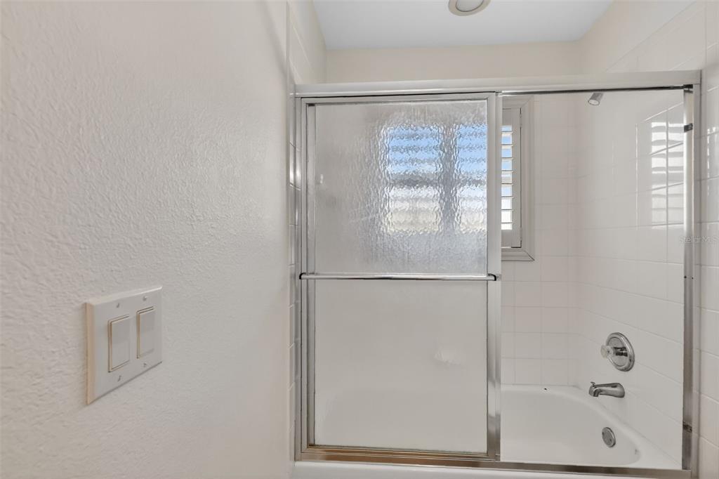 729 Strihal Loop Oakland, FL 34787 - Photo 37 of 49 a bathroom with a glass shower door