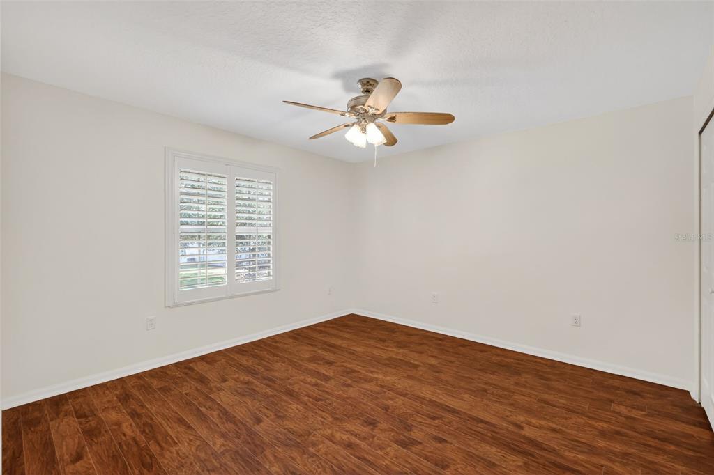 729 Strihal Loop Oakland, FL 34787 - Photo 41 of 49 a view of a big room with wooden floor and a chandelier fan