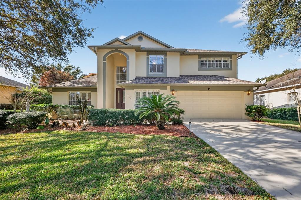 729 Strihal Loop Oakland, FL 34787 - Photo 8 of 49 a front view of a house with a yard