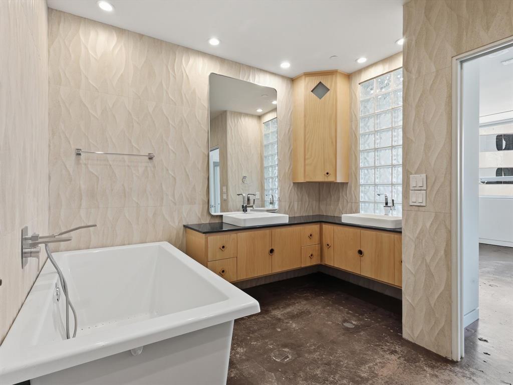 511 North Akard Street, Unit 1505 Dallas, TX 75201 - Photo 12 of 39 The luxurious primary bathroom features his/her vanities