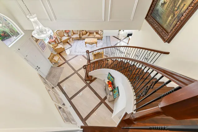 a living room with furniture flat screen tv and a large window