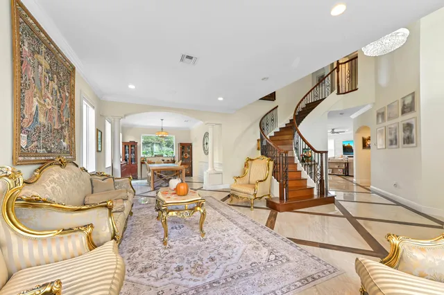a living room with a couch a window and a flat screen tv