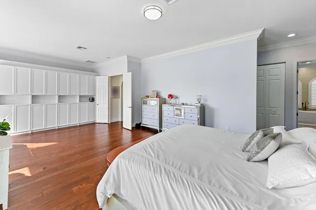 a view of a white house with a yard patio and couches chairs