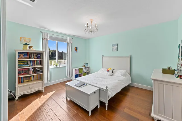 a front view of a house with a yard and potted plants