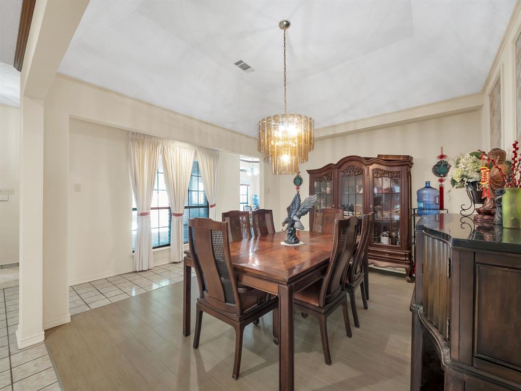10211 Shadow Way Dallas, TX 75243 - Photo 14 of 39 a view of a dining room with furniture and chandelier