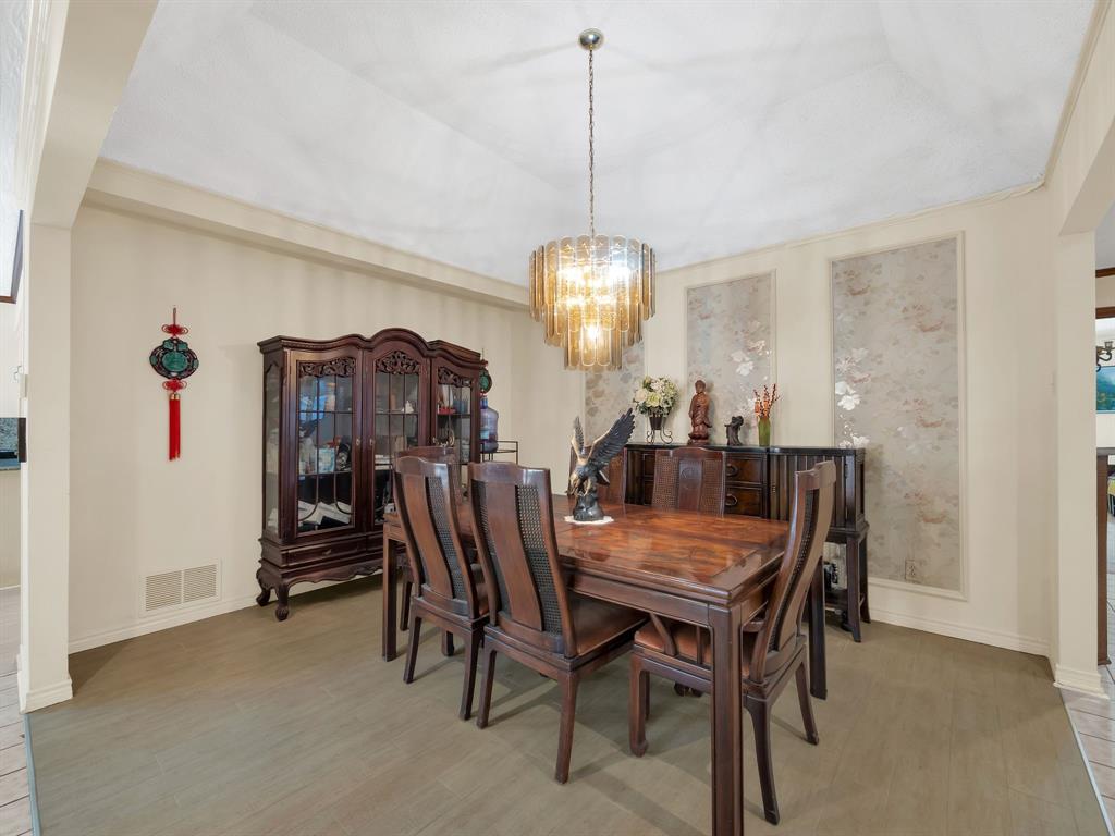10211 Shadow Way Dallas, TX 75243 - Photo 15 of 39 a view of a dining room with furniture and chandelier