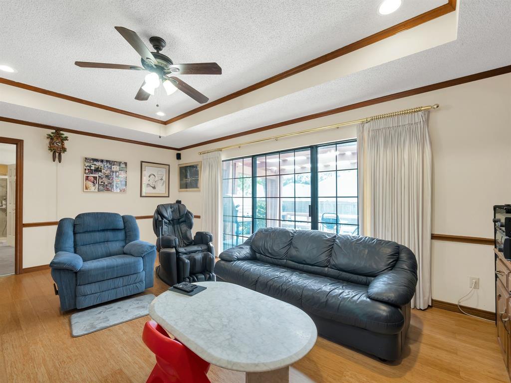 10211 Shadow Way Dallas, TX 75243 - Photo 19 of 39 a living room with furniture ceiling fan and a wooden floor