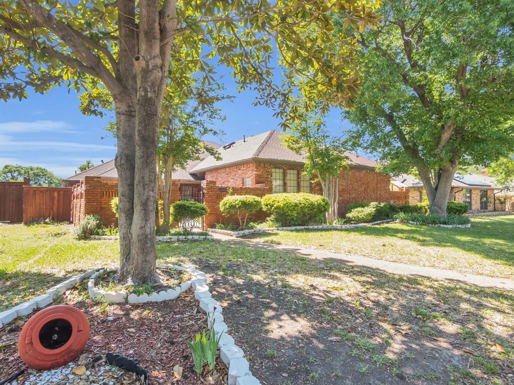 10211 Shadow Way Dallas, TX 75243 - Photo 2 of 39 a view of a house with backyard and a tree