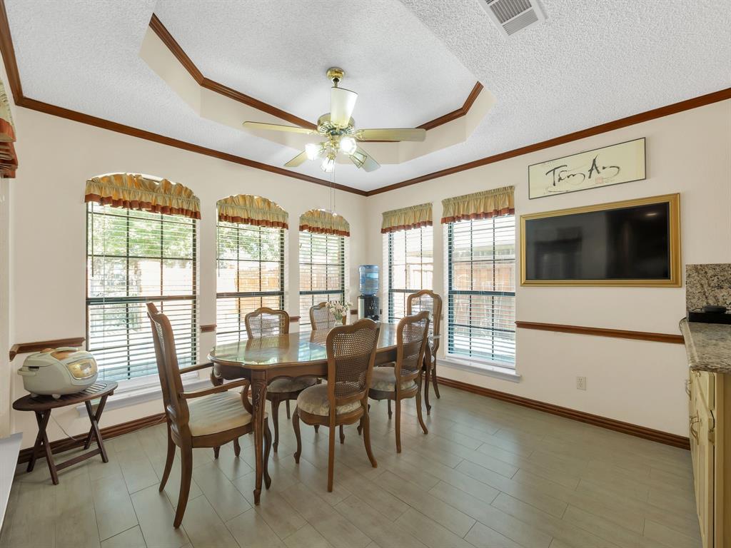 10211 Shadow Way Dallas, TX 75243 - Photo 25 of 39 a view of a dining room with furniture a chandelier and wooden floor