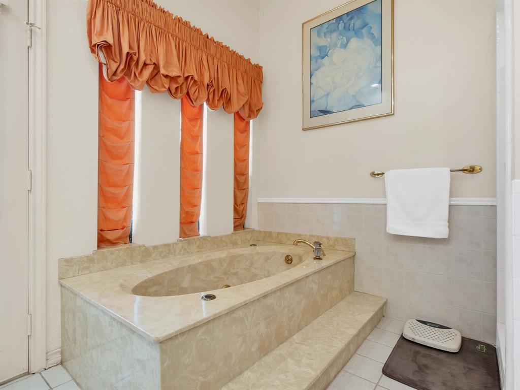 10211 Shadow Way Dallas, TX 75243 - Photo 30 of 39 a bathroom with a bath tub and a shower