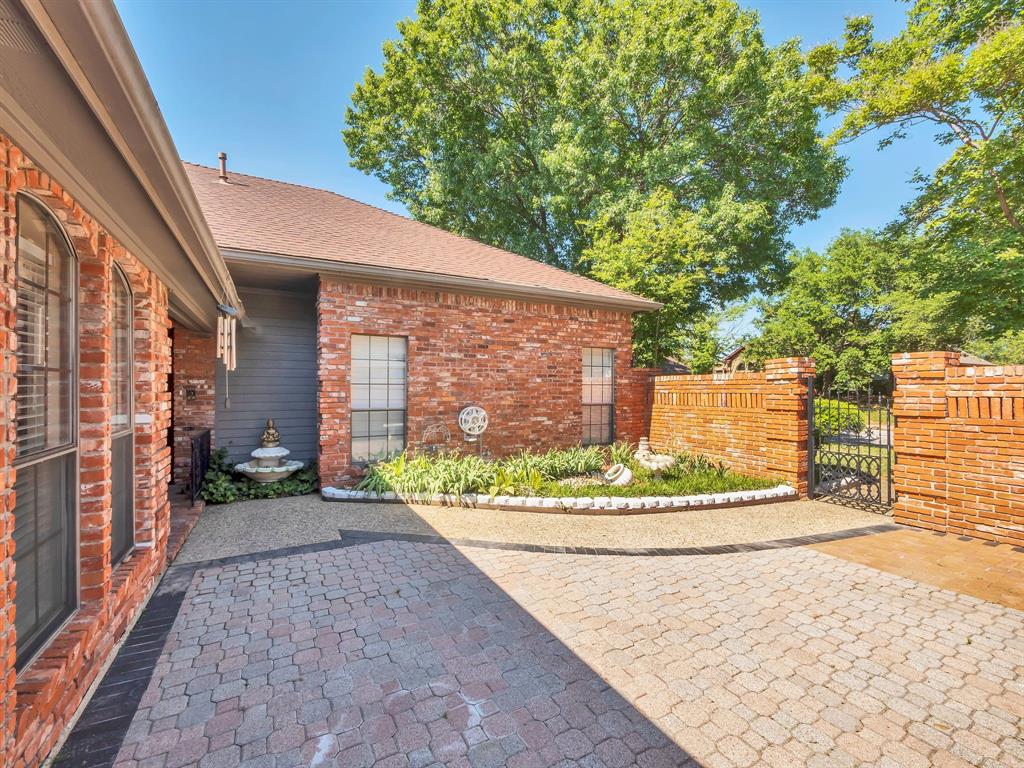 10211 Shadow Way Dallas, TX 75243 - Photo 3 of 39 a view of a pathway along a building