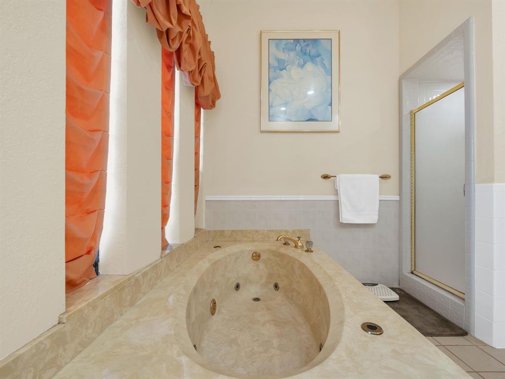 10211 Shadow Way Dallas, TX 75243 - Photo 31 of 39 a bathroom with a tub and shower