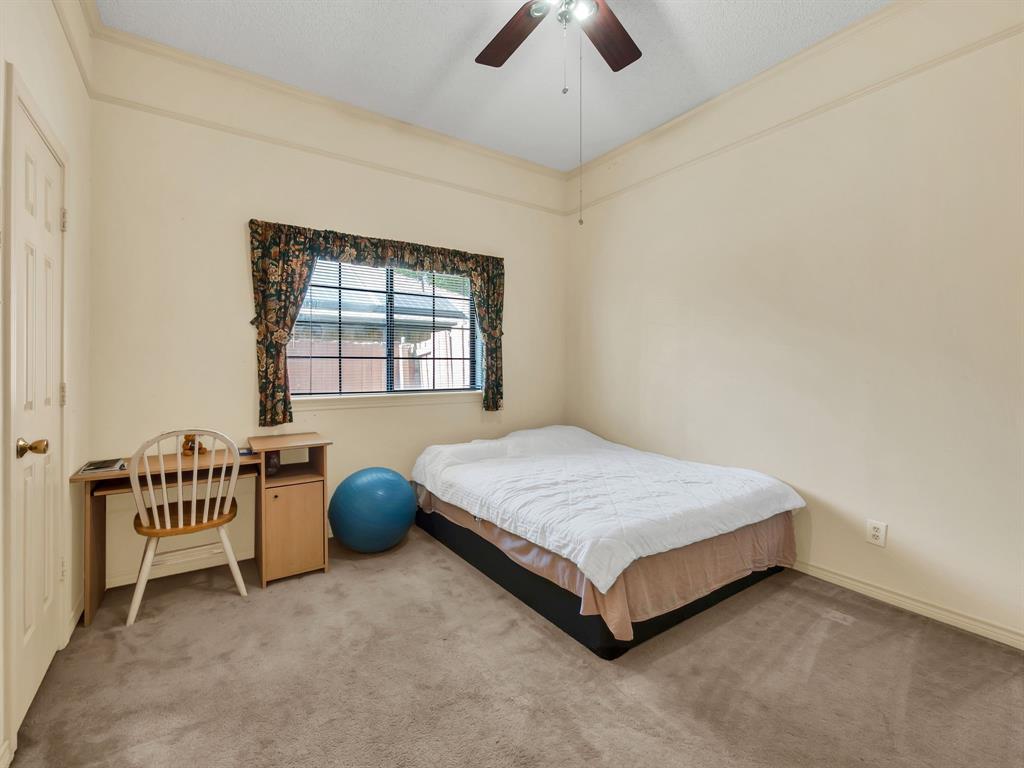 10211 Shadow Way Dallas, TX 75243 - Photo 32 of 39 a spacious bedroom with a bed and a window