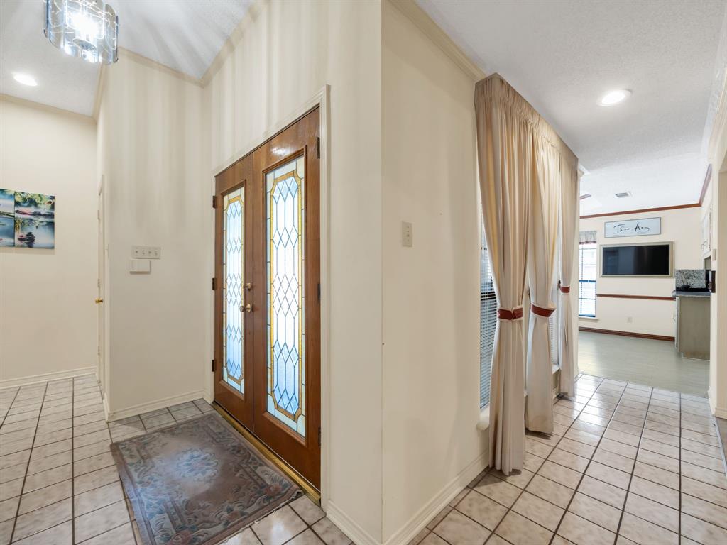 10211 Shadow Way Dallas, TX 75243 - Photo 8 of 39 a view of a hallway view with wooden floor and staircase
