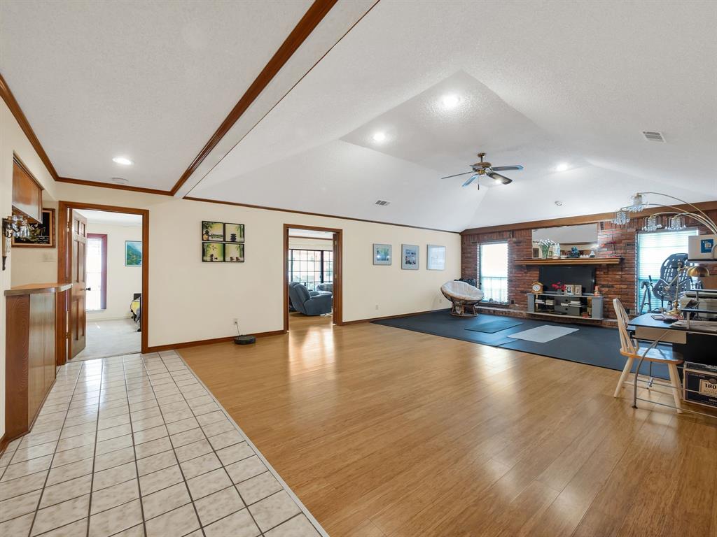 10211 Shadow Way Dallas, TX 75243 - Photo 9 of 39 a view of a living room a kitchen with furniture and wooden floor