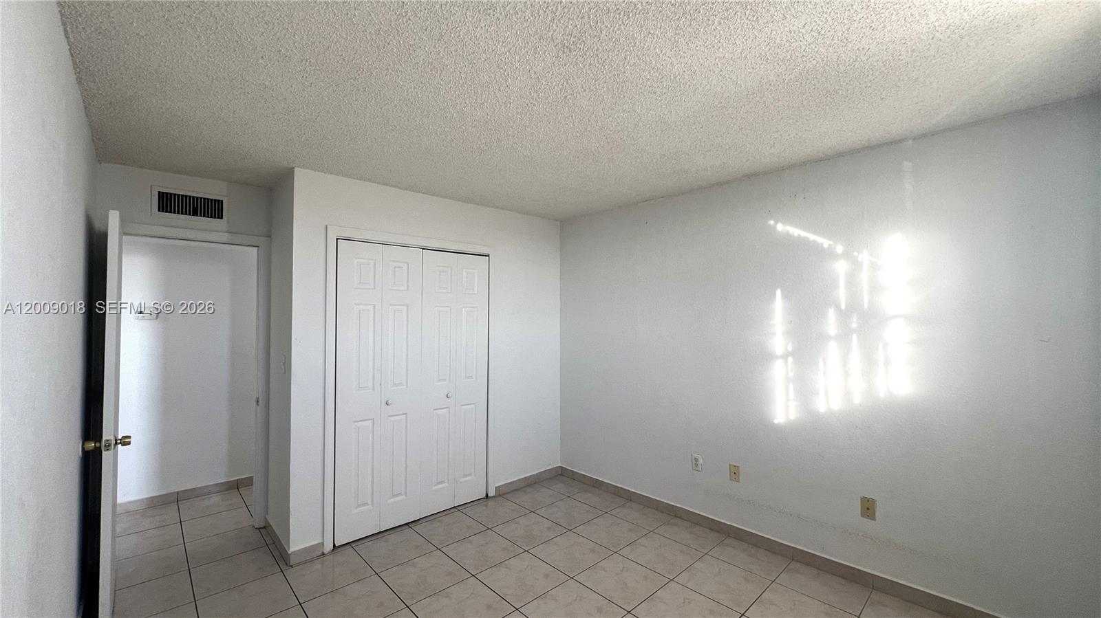 666 West 81st Street, Unit 304 Hialeah, FL 33014 - Photo 12 of 21 an empty room with windows and closet