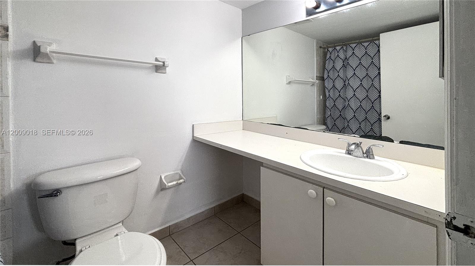 666 West 81st Street, Unit 304 Hialeah, FL 33014 - Photo 13 of 21 a bathroom with a sink a toilet and shower