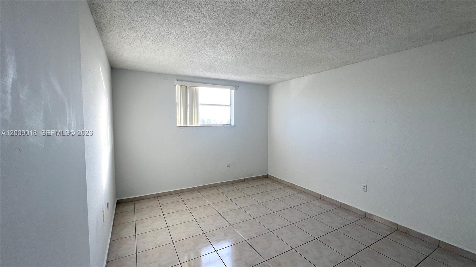 666 West 81st Street, Unit 304 Hialeah, FL 33014 - Photo 16 of 21 an empty room with windows