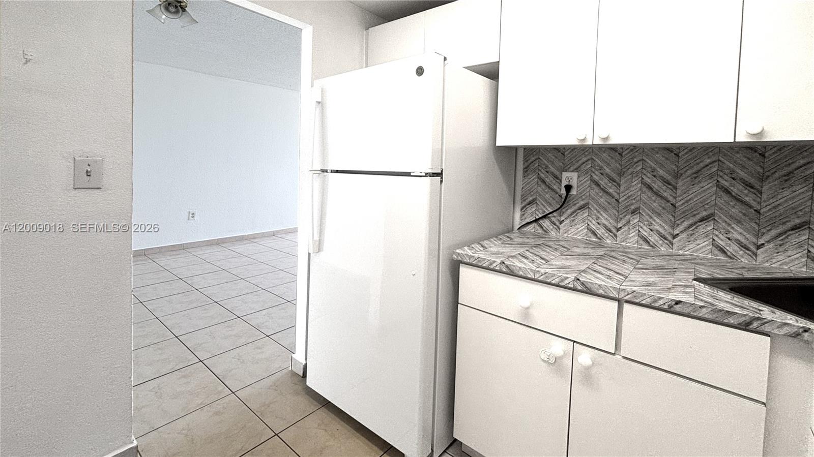 666 West 81st Street, Unit 304 Hialeah, FL 33014 - Photo 19 of 21 a kitchen with a refrigerator and a stove