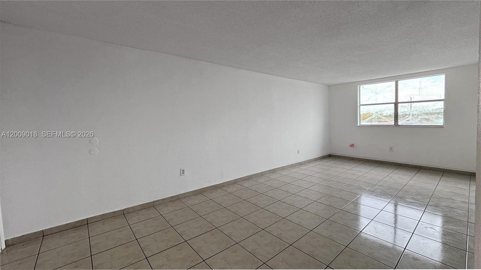 666 West 81st Street, Unit 304 Hialeah, FL 33014 - Photo 6 of 21 an empty room with windows