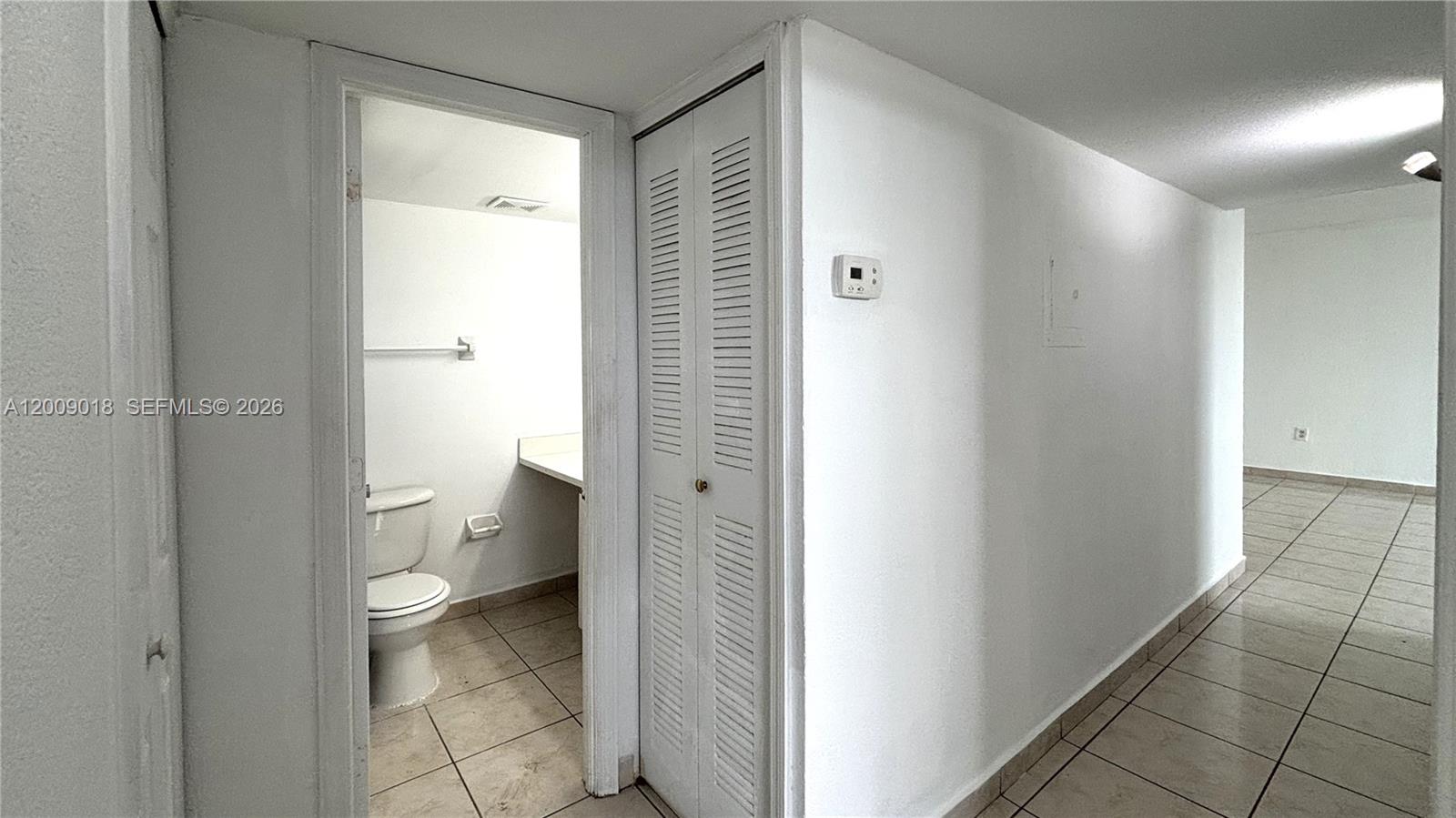 666 West 81st Street, Unit 304 Hialeah, FL 33014 - Photo 8 of 21 a bathroom with a granite countertop toilet and a shower