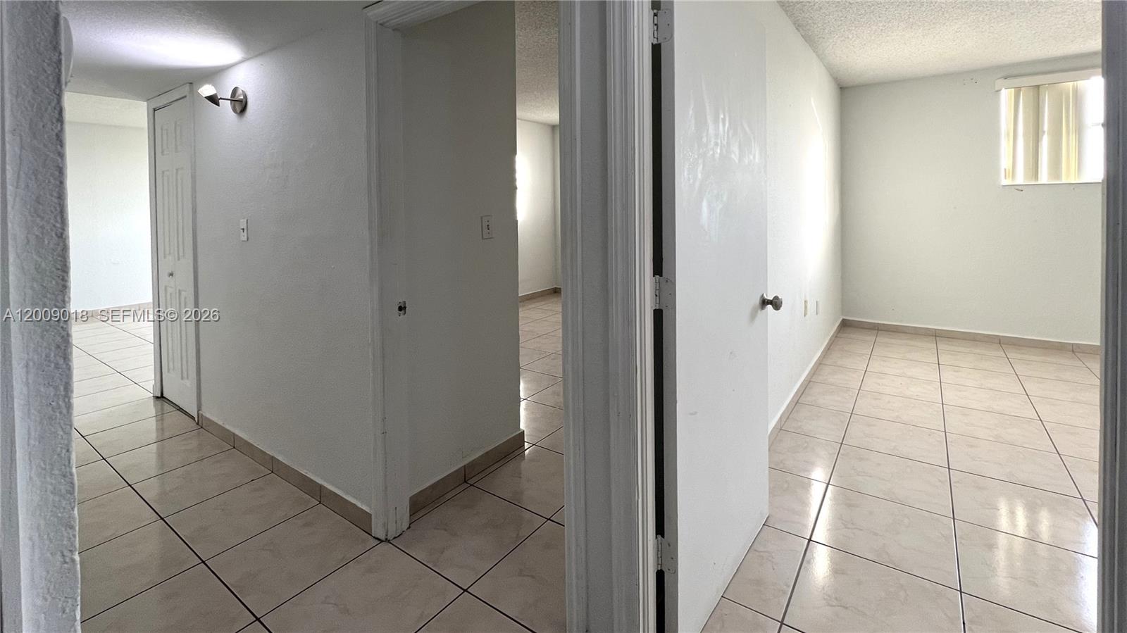 666 West 81st Street, Unit 304 Hialeah, FL 33014 - Photo 9 of 21 a view of a hallway to rooms
