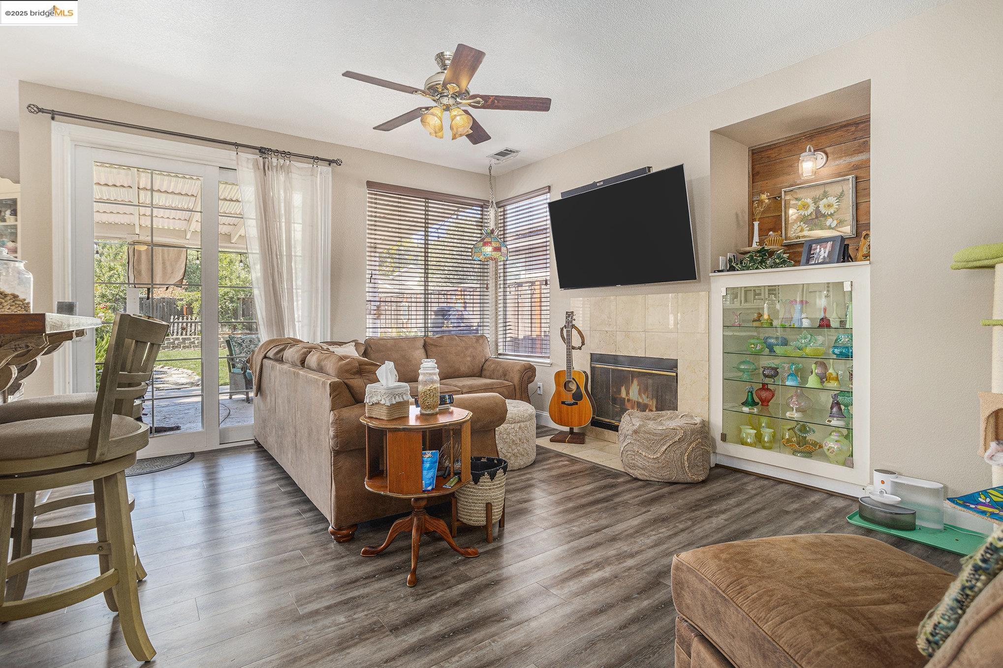 2059 Heartland Court Brentwood, CA 94513 - Photo 12 of 37 a living room with fireplace furniture and a flat screen tv
